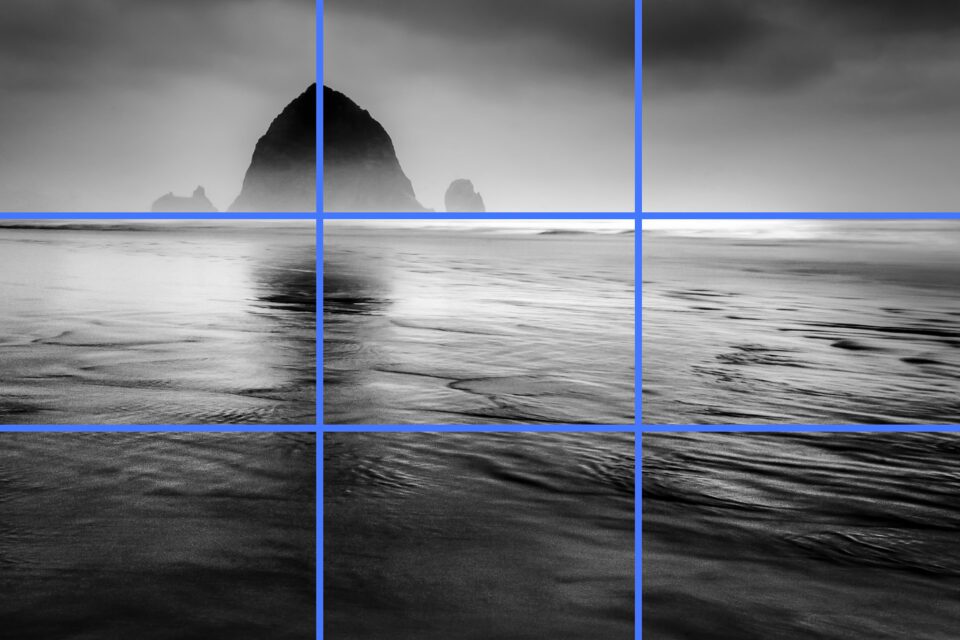 This landscape photo perfectly aligns with the rule of thirds, as demonstrated by the blue rule of thirds grid superimposed on the image.